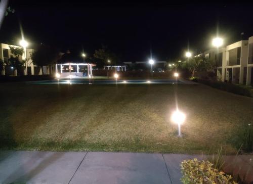 a parking lot at night with lights in the grass at Aldea Aqua - HiveNB in Tlayecac