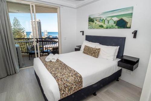 a bedroom with a bed and a balcony at Palazzo Colonnades in Gold Coast