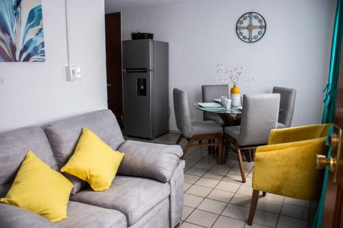 a living room with a couch and a table at Moderno Departamento 2 Centro Historico - Modern Apartment 2 Downtown in San Luis Potosí
