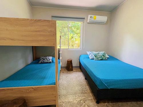 a bedroom with two bunk beds and a window at Casa Ballena with Beach Access and Private Pool in Uvita