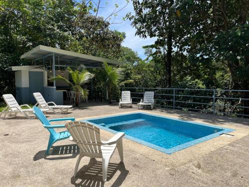 a patio with chairs and a swimming pool with a table and two chairs at Casa Ballena with Beach Access and Private Pool in Uvita