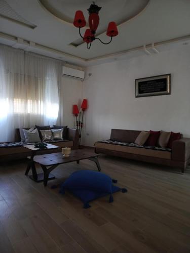 a living room with a couch and a table at Dar Latifa in Raʼs al Jabal