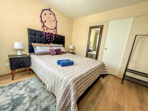 a bedroom with a large bed with a clock on the wall at Nuevo exclusivo con vista al mar - Blue One in Lima