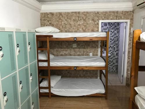 a group of bunk beds in a dorm room at Ô de casa hostel in Balneário Camboriú