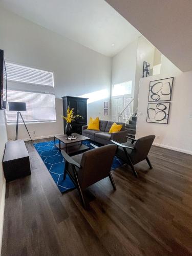a living room with a couch and a table at VEGAS GEM 4BDR KING BED Wifi GARAGE PRKNG in Las Vegas