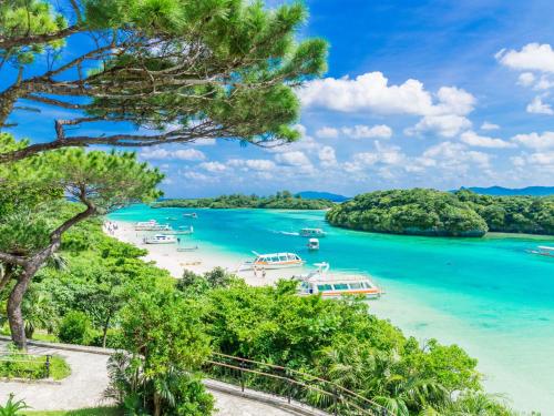 a view of a beach with boats in the water at 宿屋lotus in Ishigaki Island