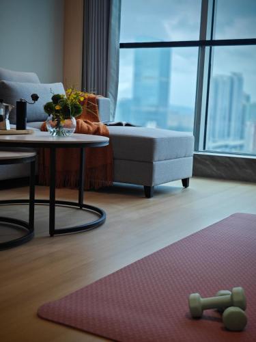 a living room with a couch and a table at Citadines Gongbei Zhuhai in Zhuhai
