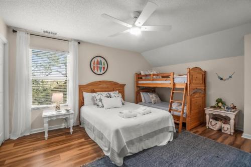a bedroom with a bed and a bunk bed at Beautifully appointed 3-Bed, 25-Bath Home, Great Location near Beach & Club in Fripp Island