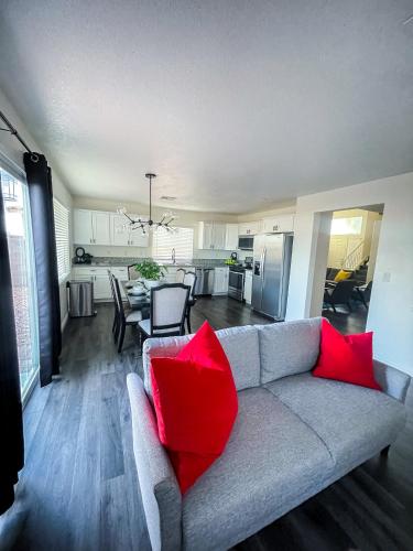 a living room with a gray couch with red pillows at VEGAS GEM 4BDR KING BED Wifi GARAGE PRKNG in Las Vegas