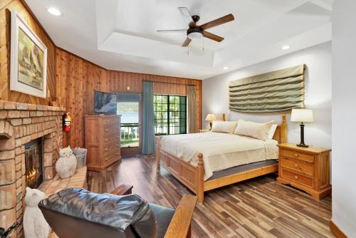a bedroom with a bed and a fireplace at Serenity Cove Lake House #2472 by Big Bear Vacations in Big Bear Lake