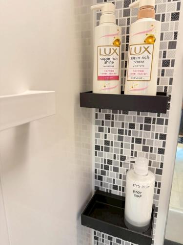 a shelf in a bathroom with toiletries on it at 宿のきむら in Utsunomiya