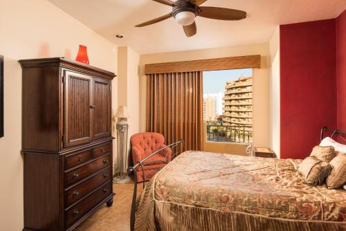 a bedroom with a bed and a dresser and a window at Bella Sirena BA 505 As Good As It Gets Beautiful Ocean View Condo in Puerto Peñasco