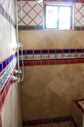 a shower in a bathroom with a window at Las Gaviotas 402 Mid-century Ocean View Apartment in Puerto Peñasco