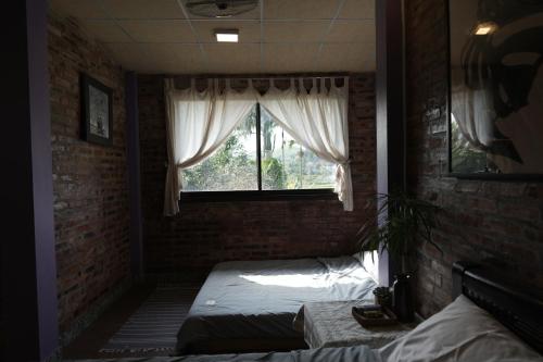 a bedroom with two beds and a window at mehome in Cư Chinh