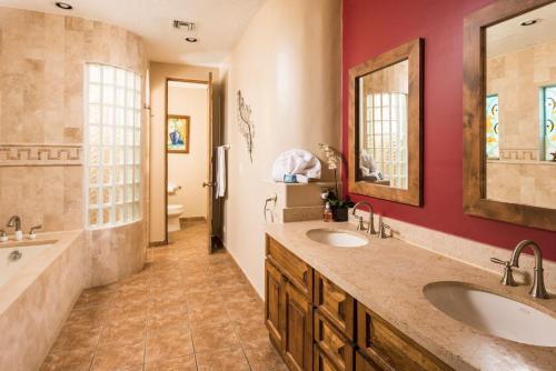 a bathroom with two sinks and a large mirror at Bella Sirena BA 505 As Good As It Gets Beautiful Ocean View Condo in Puerto Peñasco