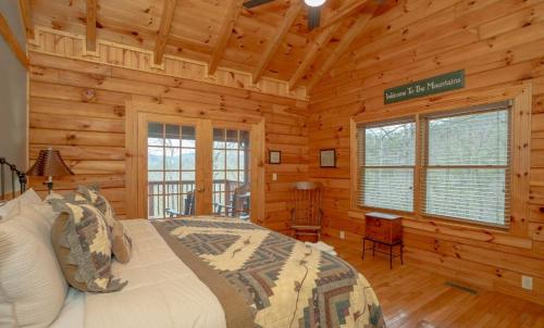 a bedroom with a bed in a log cabin at Homestead Hideaway in Sevierville