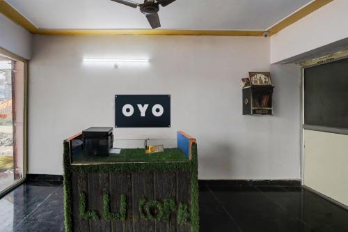 an office with a desk with a sign on the wall at Hotel O KAVYA RESIDENCY in Alīgarh