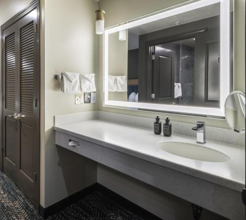 a bathroom with a sink and a mirror at The Rockwell Inn in Jackson