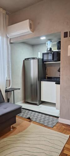 a kitchen with a stainless steel refrigerator in a room at Apê moderno no Largo do Machado in Rio de Janeiro