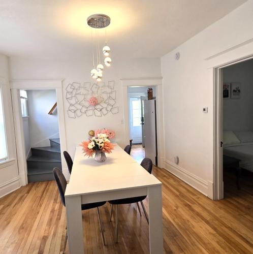 a dining room and living room with a table and chairs at Pinkston Gardens in Saint Paul