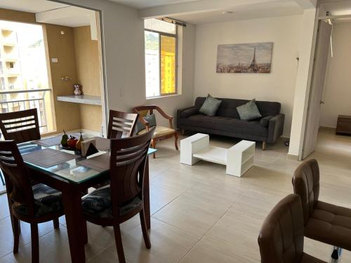 a living room with a table and a couch at Apartamento de descanso y relajación en Villeta in Villeta