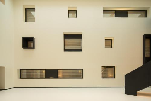 a wall of windows in a building at SFEEL设计师酒店 Designer Hotel成都春熙路IFS国金中心店 in Chengdu
