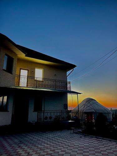 a house with a tent in front of it at Maksat house in Tossor