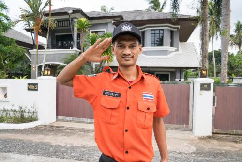 a man wearing an orange shirt and a hat at Baan Santhiya Private Pool Villas - Free Tuk-Tuk Service to the Beach! in Ao Nang Beach