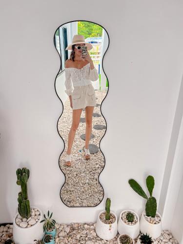 a woman taking a picture of herself in a mirror at บ้านพักเขาใหญ่ ลูกแก้วพูลวิลล่า Lookkaew Pool Villa Khaoyai in Ban Rai Khlong Sai