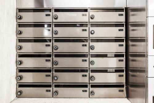 a stack of metal lockers in a building at JR Kamata Station is a 3-minute walk, Shinagawa is 7 minutes by train, and Keikyu Kamata Station has direct access to Haneda Airport, Tokyo, Shinagawa, Yokohama, and Ueno in Tokyo