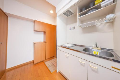 a kitchen with white cabinets and a sink at JR Kamata Station is a 3-minute walk, Shinagawa is 7 minutes by train, and Keikyu Kamata Station has direct access to Haneda Airport, Tokyo, Shinagawa, Yokohama, and Ueno in Tokyo