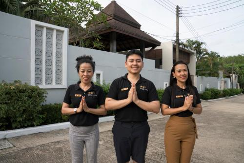 a man and two women standing in front of a house at Narintara Private Pool Villas - Free Tuk-Tuk Service to the Beach! in Ao Nang Beach