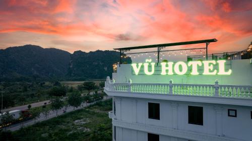 a building with a hotel sign on top of it at Vũ Hotel in Ninh Binh