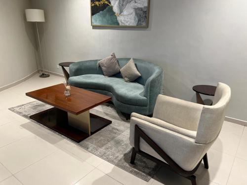 a living room with a couch and a chair and a table at Trizen Colombo Luxury 3BR Smart Apartment with Breathtaking Views & Designer Furnishings in Colombo