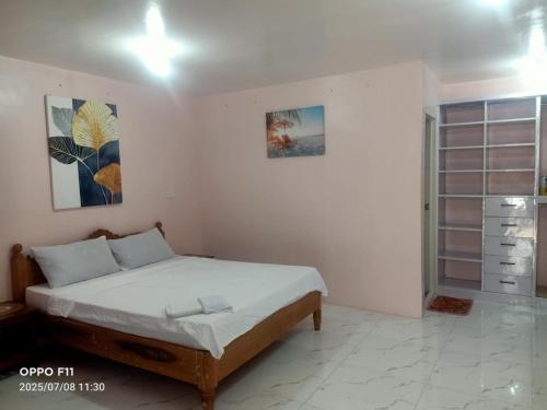 a bedroom with a bed in a room at Jch Apartment 17 Padua St Dubinan West in Santiago City