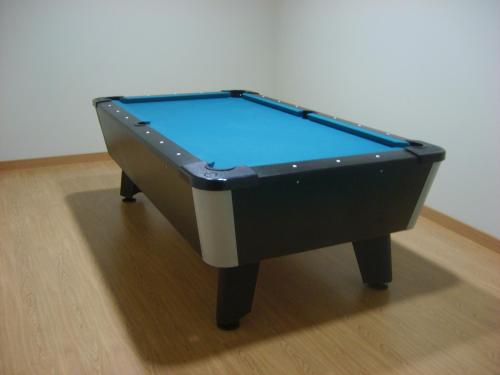 a pool table sitting on top of a wooden floor at Aparthotel Bubal in El Pueyo de Jaca
