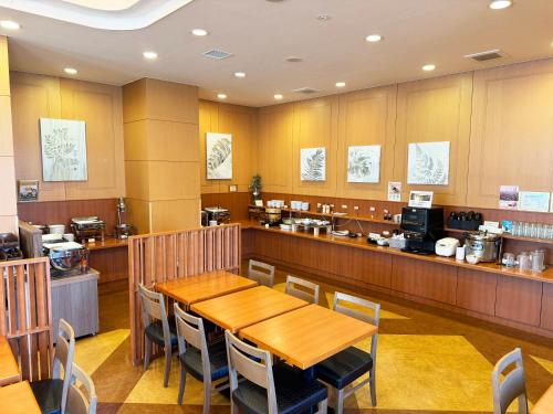 a restaurant with a table and chairs and a counter at Route Inn Grantia Shiretoko -Shari Ekimae- in Shari
