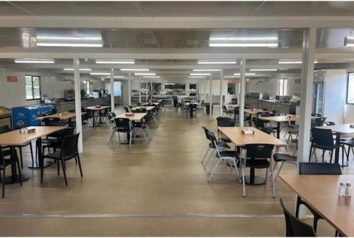 a dining room with tables and chairs and tablesktop at Discovery Parks Workstay Villages -Tindal Village in Katherine