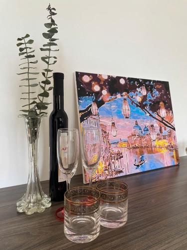 a table with two glasses and a bottle of wine at Cibi's Homestay - Tra Khuc riverside in An Bình (1)