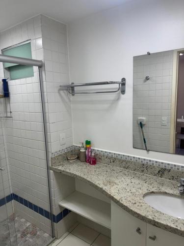 a bathroom with a sink and a mirror at Serra Park in Rio Quente