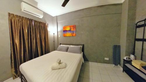 a bedroom with a large bed with a hat on it at 2-9pax GFloor PRIVATE BEACH, WATERSPORT, POOL, FREE BBQ Set, Wifi, 50"TV in Port Dickson