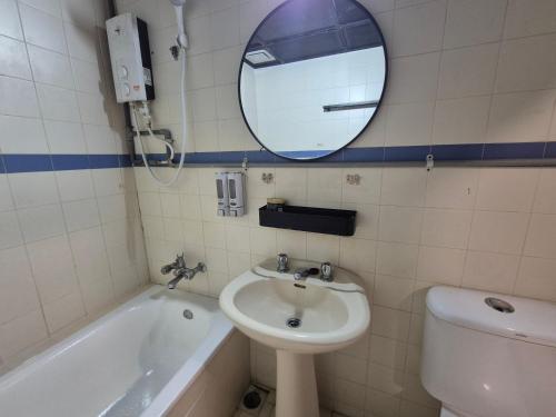 a bathroom with a sink and a tub and a mirror at 2-9pax GFloor PRIVATE BEACH, WATERSPORT, POOL, FREE BBQ Set, Wifi, 50"TV in Port Dickson