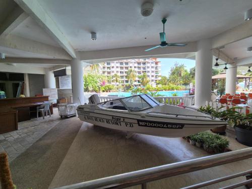 a boat sitting on the floor of a house at 2-9pax GFloor PRIVATE BEACH, WATERSPORT, POOL, FREE BBQ Set, Wifi, 50"TV in Port Dickson