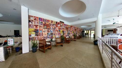 a restaurant with a long corridor with tables and chairs at 2-9pax GFloor PRIVATE BEACH, WATERSPORT, POOL, FREE BBQ Set, Wifi, 50"TV in Port Dickson