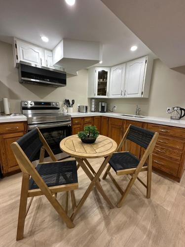 a kitchen with a table and two chairs and a table at The Perfect Getaway in Orangeville