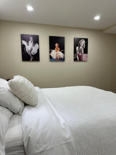 a bedroom with four pictures on the wall at The Perfect Getaway in Orangeville