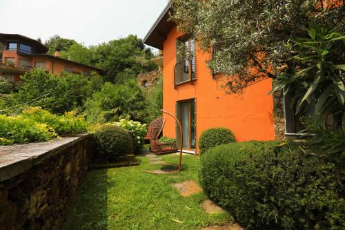 an orange house with a garden in front of it at Villetta Isabella in Menaggio