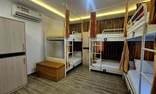 a room with three bunk beds in a room at City Backpackers Hostel in Ho Chi Minh City