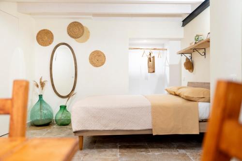 a bedroom with a bed and a mirror on the wall at Desideri di Puglia in Barletta
