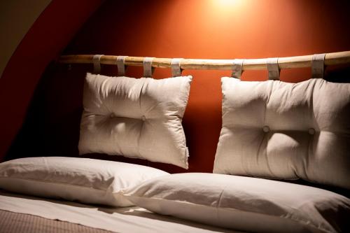 a bed with two pillows on top of it at Desideri di Puglia in Barletta